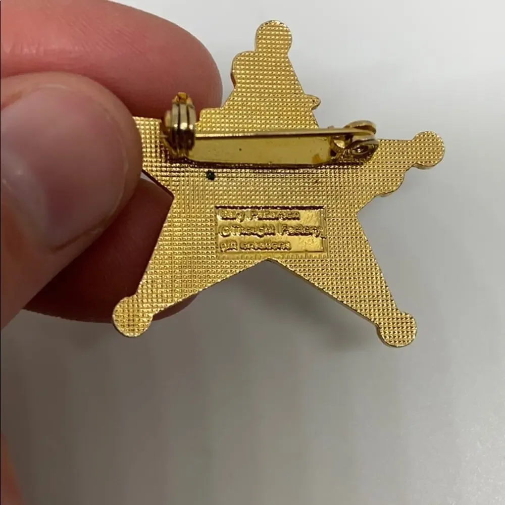 A cowboy on a Rockinghorse sheriff star pin